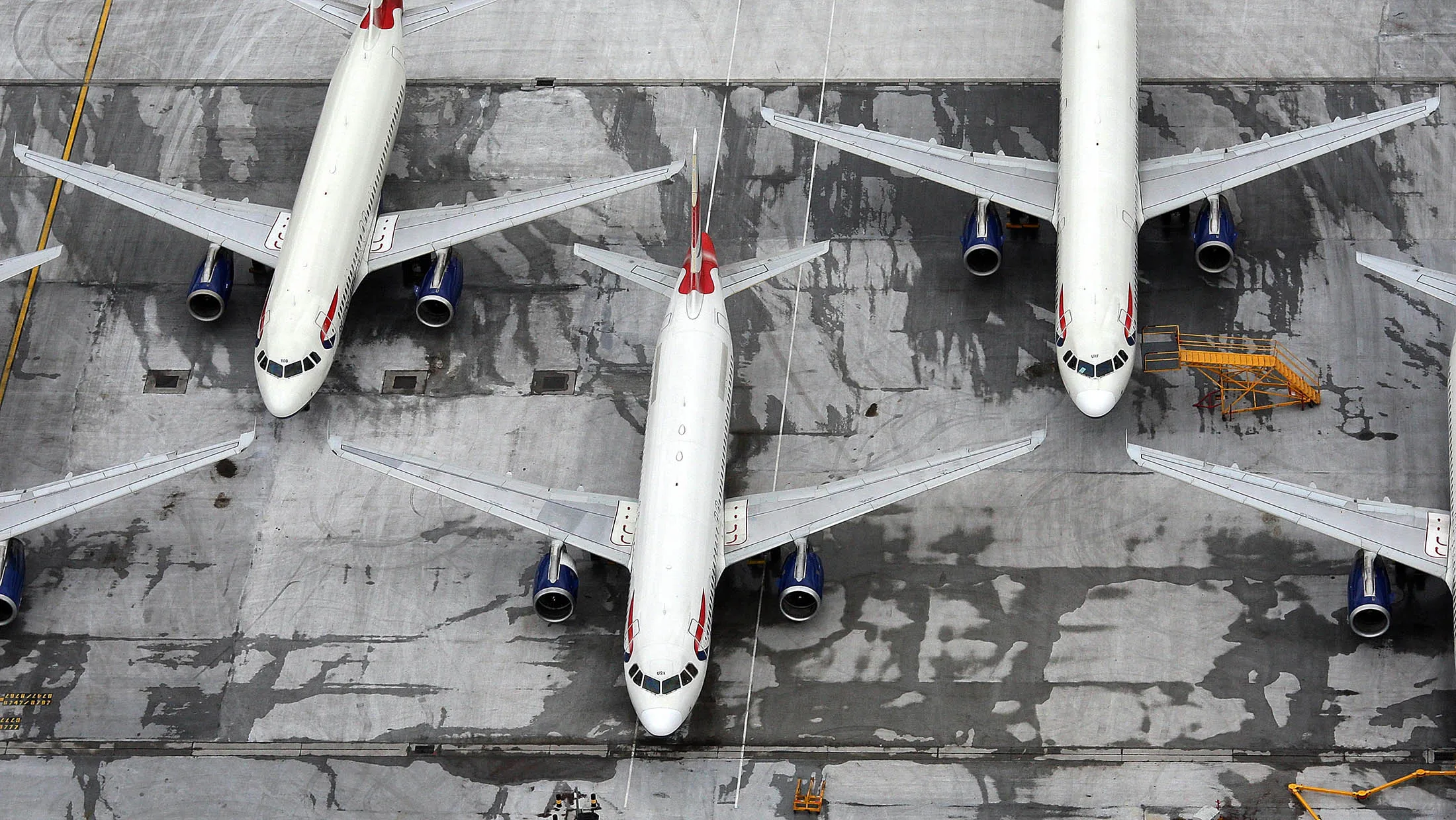 British Airways aircraft sit on the ground in this aerial view of Heathrow Airport in London, U.K., on Monday, March 29, 2010. British Airways PlcÕs cabin-crew union said itÕs no closer to returning to negotiations with management on the third day of a four-day strike by 12,000 workers over pay and staffing levels.
