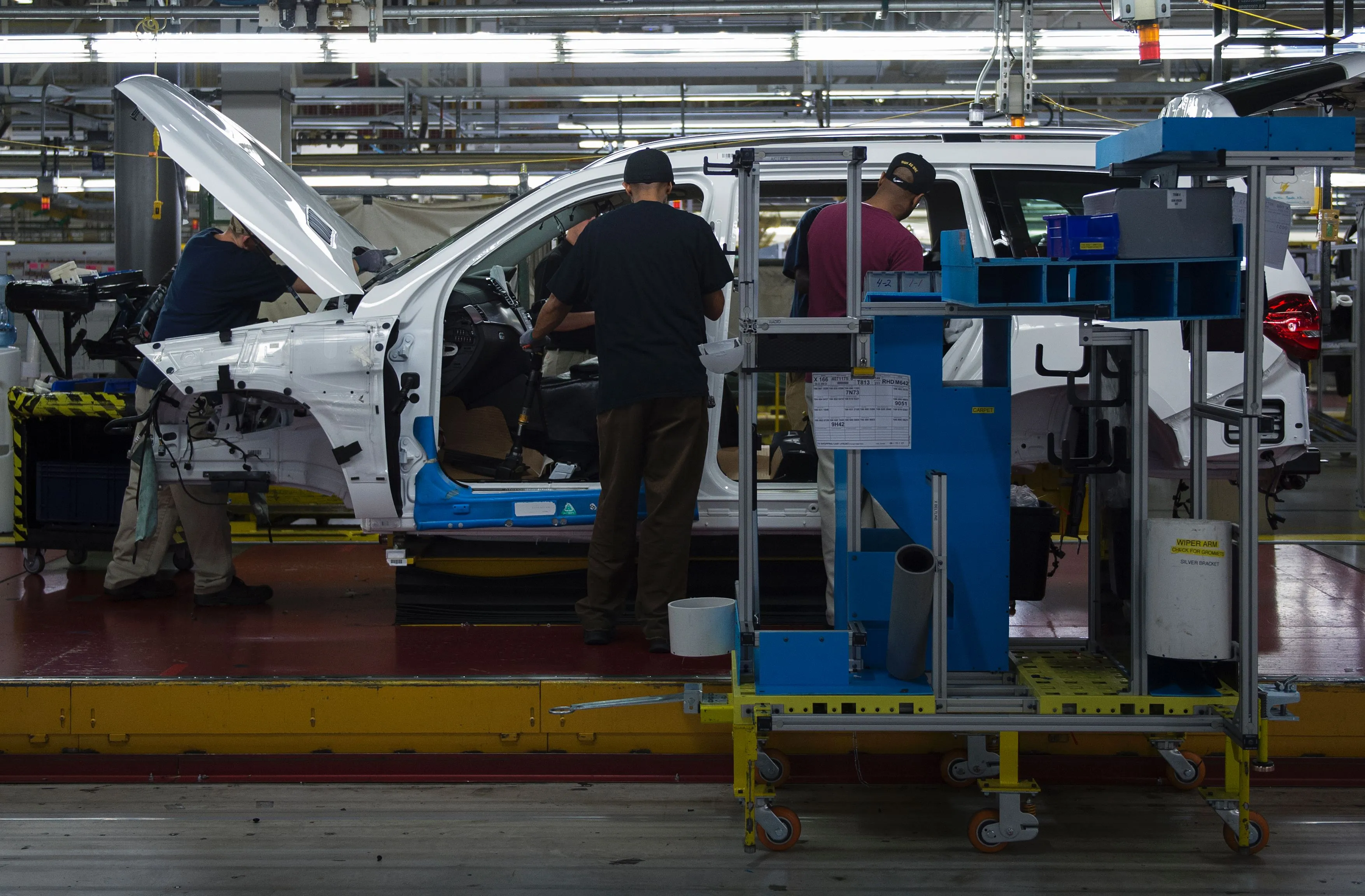 Employees install parts onto a vehicle&nbsp;on the production line at the Mercedes-Benz factory in Vance, Alabama.