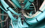 Coaxial cables connect to a computer server unit inside a communications room at an office in London, U.K., on Monday, May 15, 2017. Governments and companies around the world began to gain the upper hand against the first wave of an unrivaled globalcyberattack, even as the assault was poised to continue claiming victims this week.