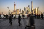 Visitors walk on the Bund in Shanghai.