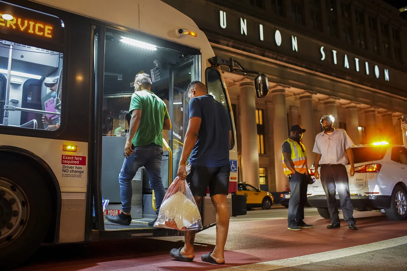 A group of migrants board a CTA bus at Chicago's Union Station after arriving from Texas on Aug. 31.