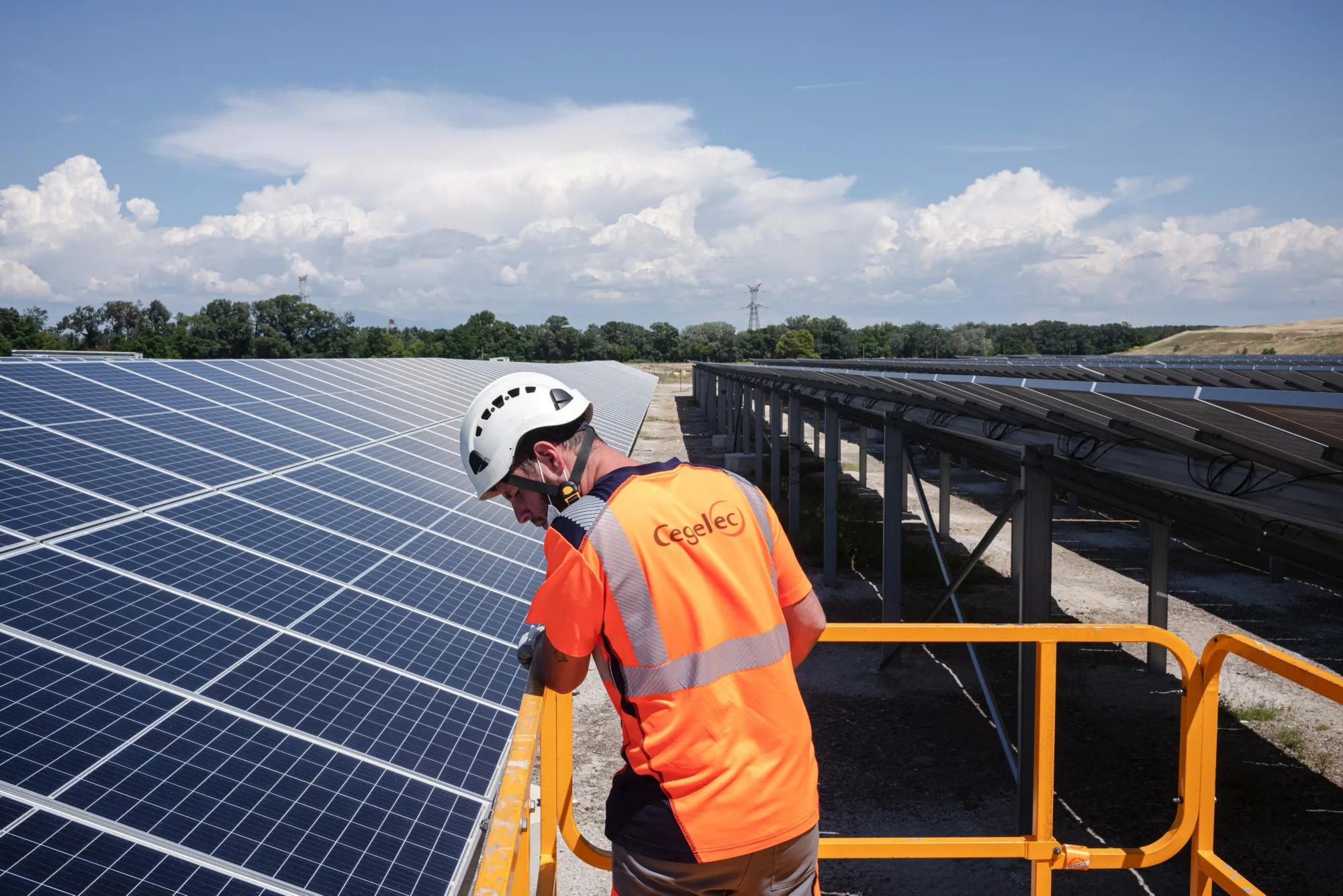 A construction worker overlooks the under construction Renewable Energy Systems Ltd. solar park, on a former ArcelorMittal SA metals plant site in Laudun L'Ardoise, France, on Wednesday, June 9, 2021.&nbsp;