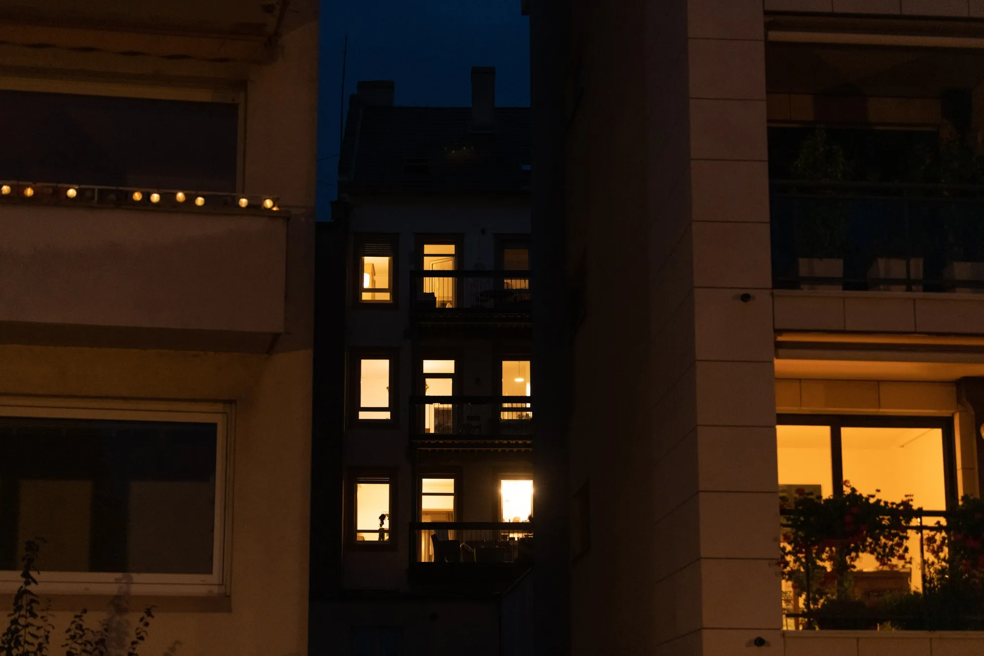 A partially-lit apartment block at night in a residential district of Strasbourg, France.