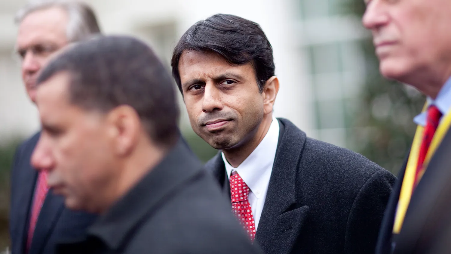 Bobby Jindal, governor of Louisiana, center, listens during a news conference outside the White House with other governors after a meeting with U.S. President Barack Obama in Washington, D.C., U.S., on Monday, Feb. 22, 2010.
