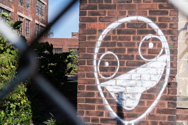 Face wearing a mask on a wall of the old Remington Arms plant, Bridgeport, Connecticut  
