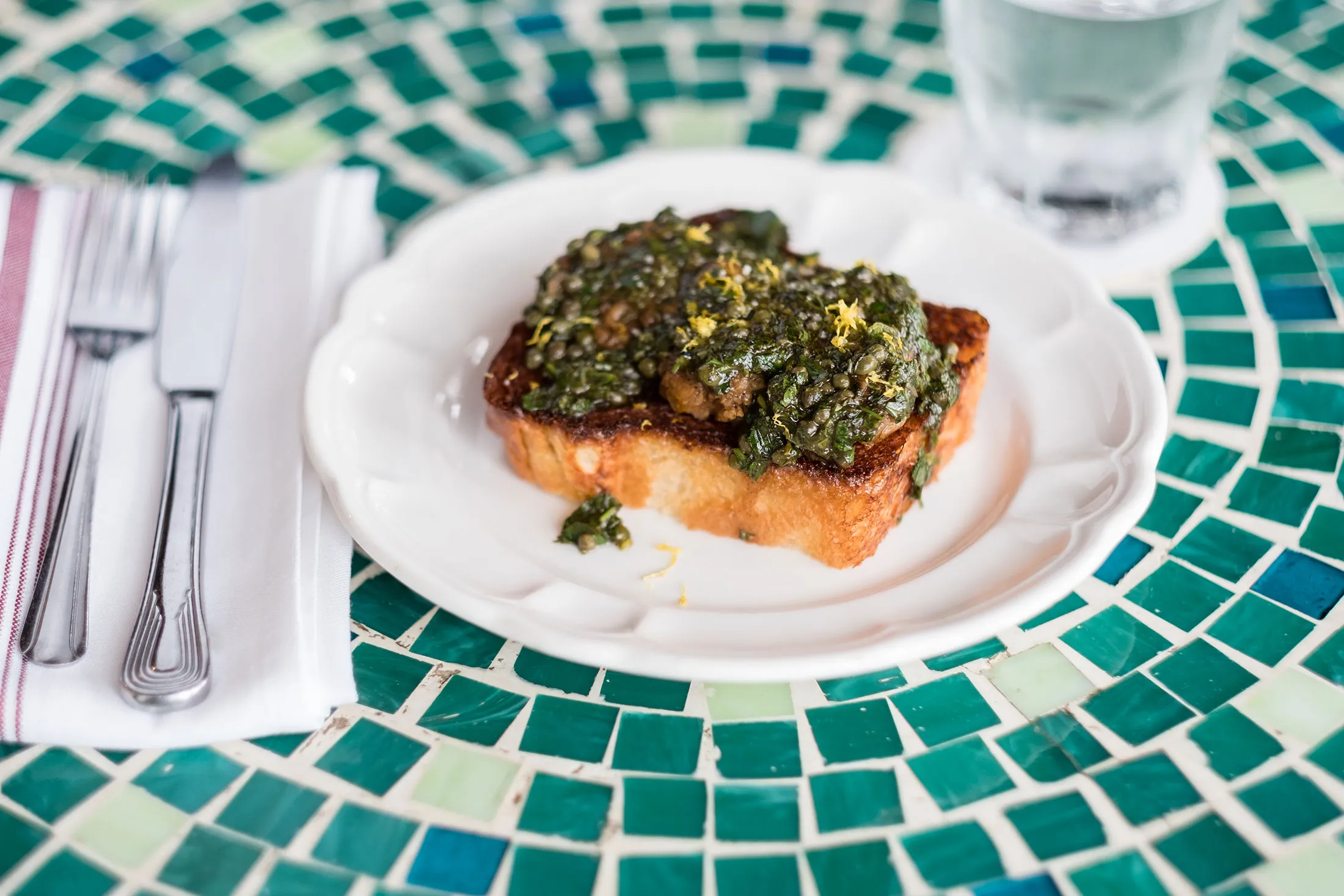 Calf Brain Toast, prepared with lemon and herbs, at Cafe Marie Jeanne in Chicago.