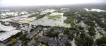 Neighborhoods near Addicks Reservoir are flooded by rain from Tropical Storm Harvey on Tuesday.