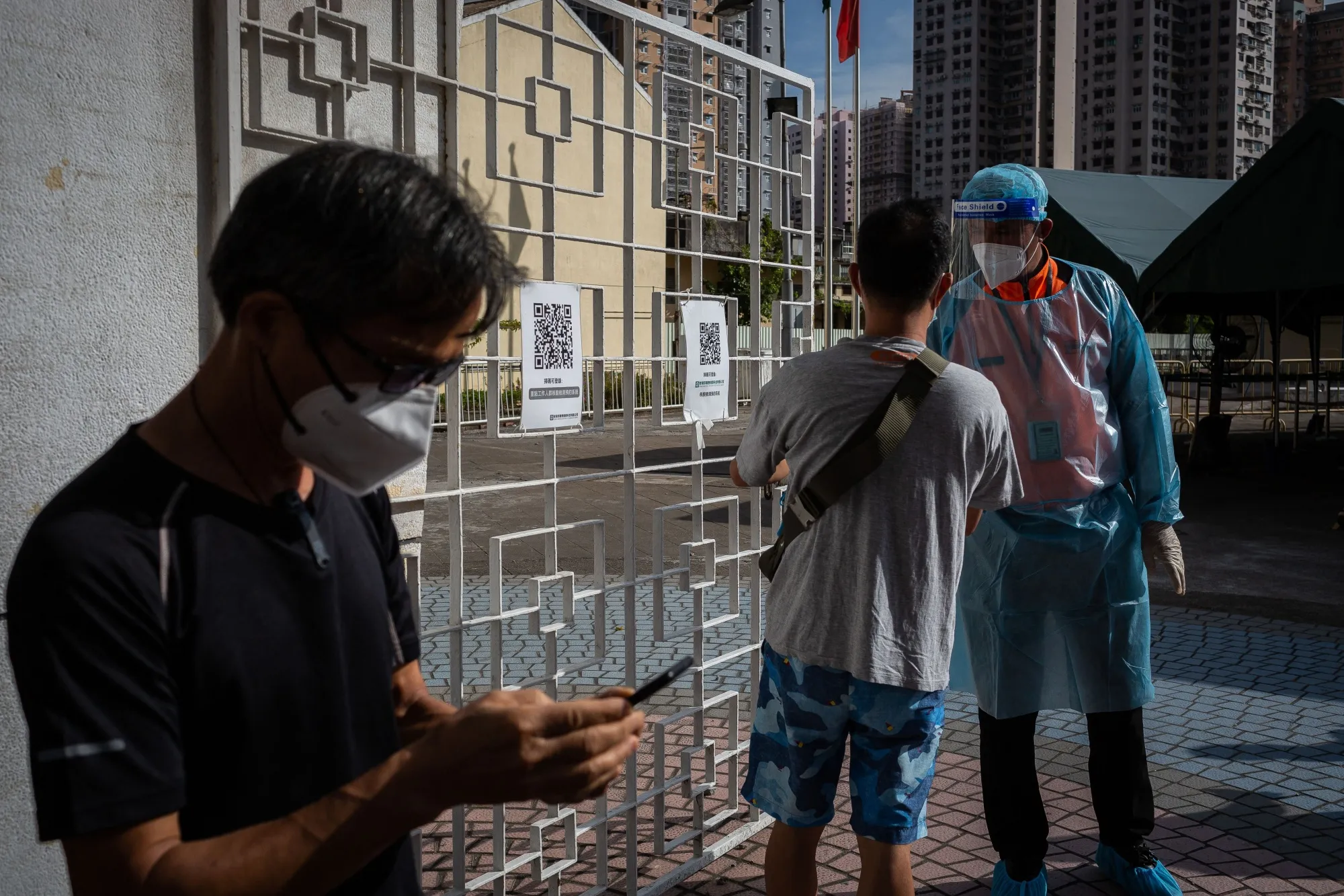 A health workers gives informations to a resident during Covid-19 tests of the entire population in Macau on Nov. 1.