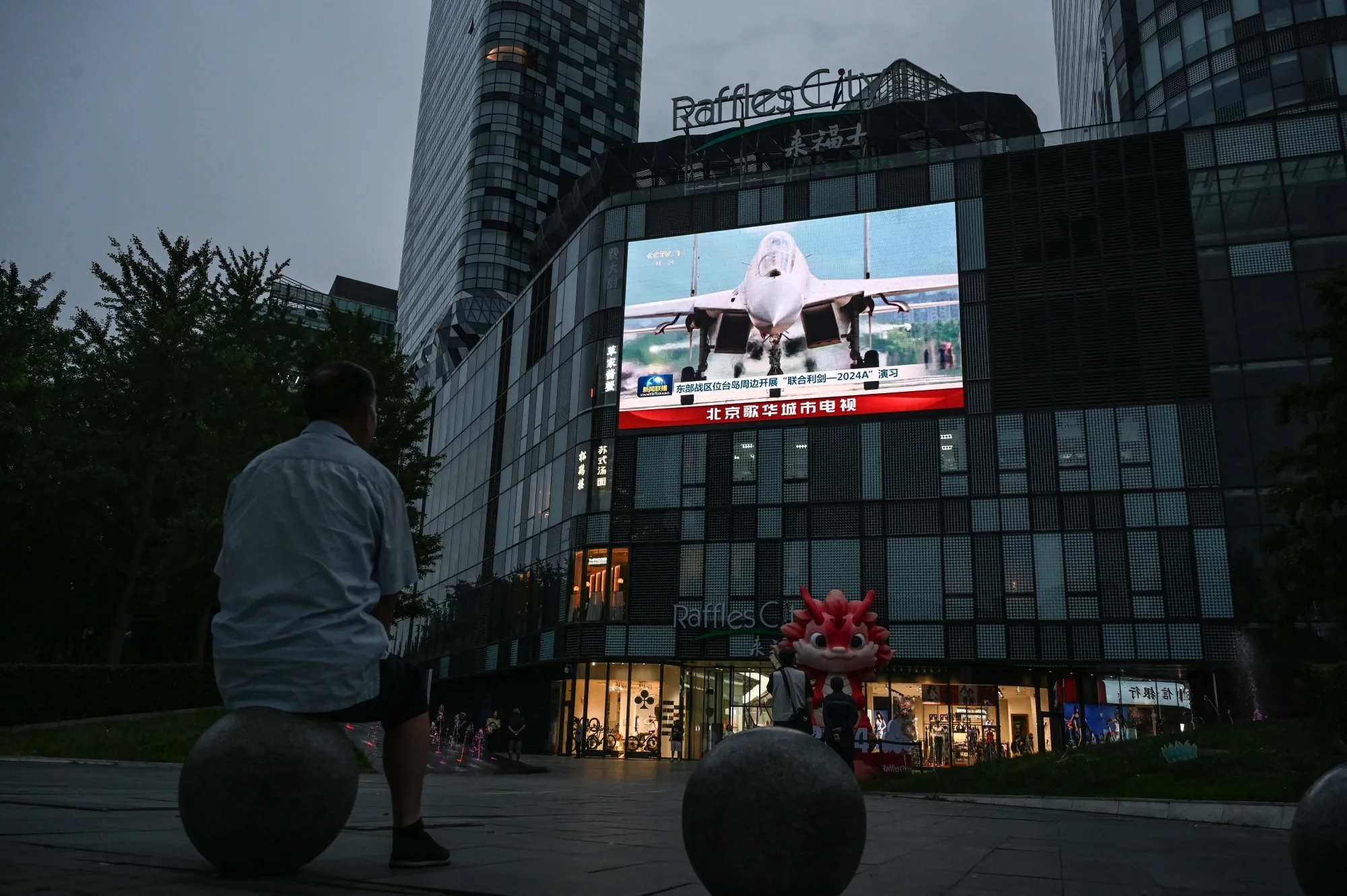 An outdoor screen shows a news coverage of China’s military drills around Taiwan, in Beijing on May 23.