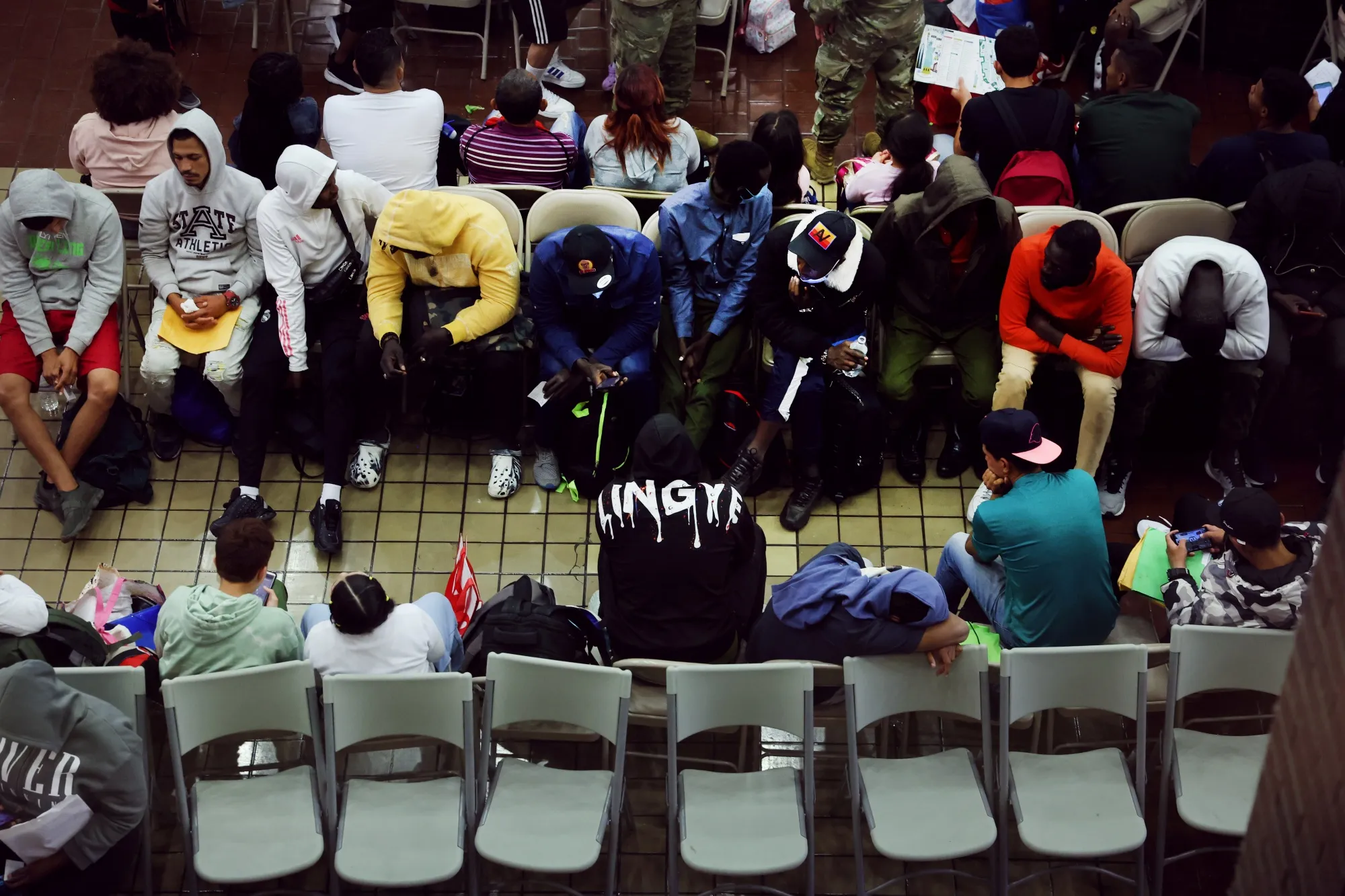 Newly arrived asylum seekers wait at the Port Authority bus terminal&nbsp;in New York City.&nbsp;