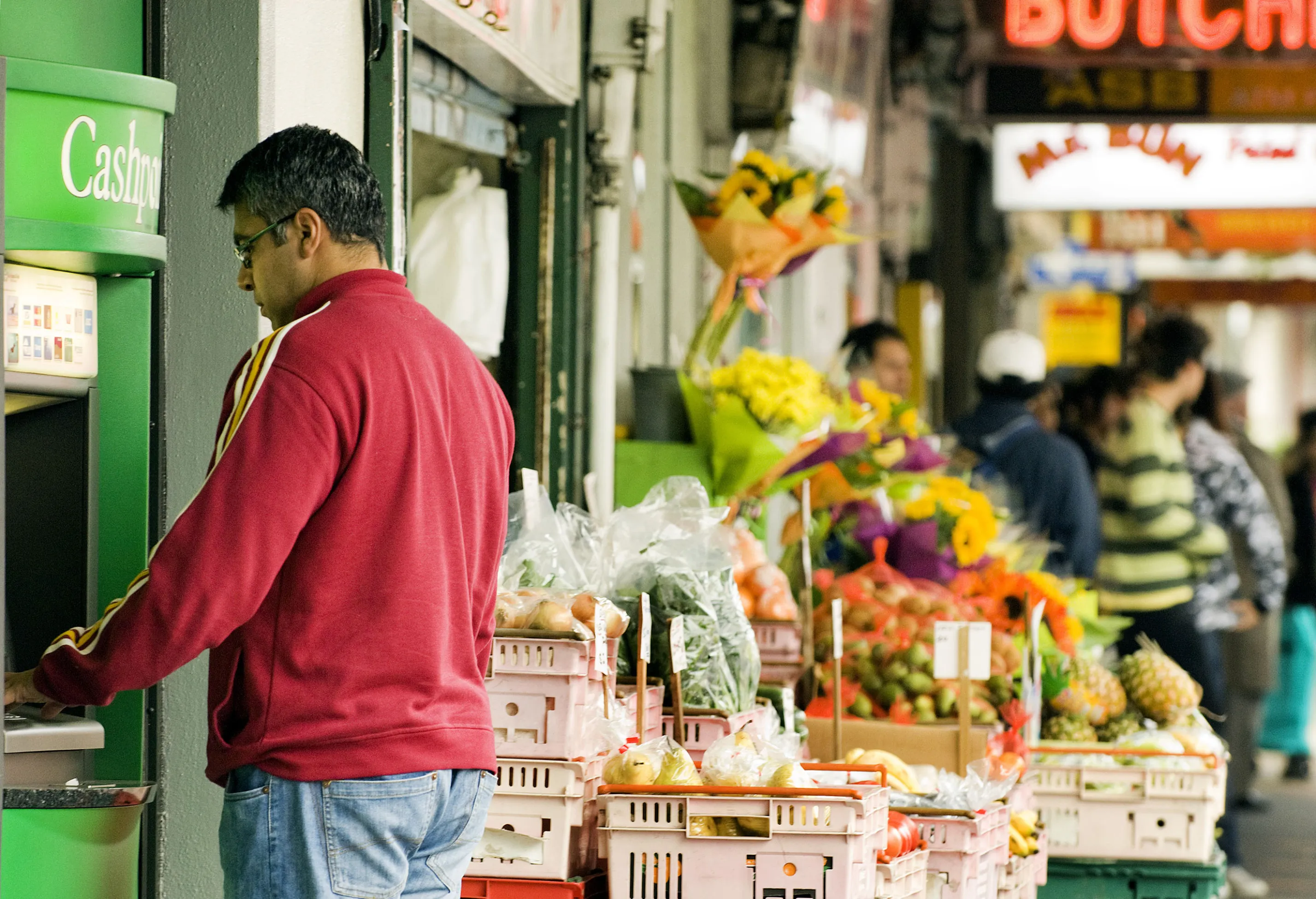 A shopper uses an ATM at a grocery store&nbsp;in Wellington, New Zealand.
