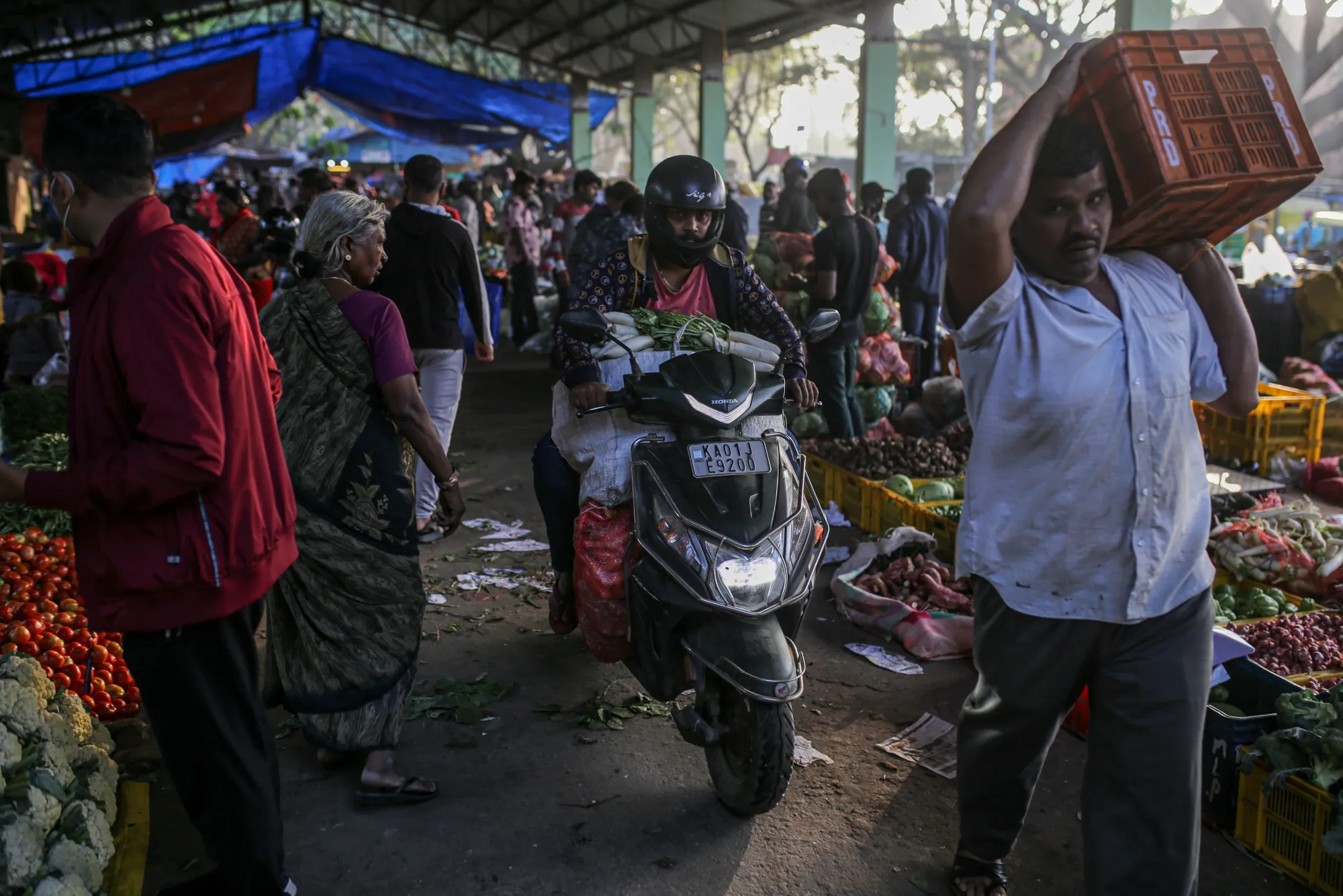 Customers buy vegetables at a wholesale market in Bengaluru, India.