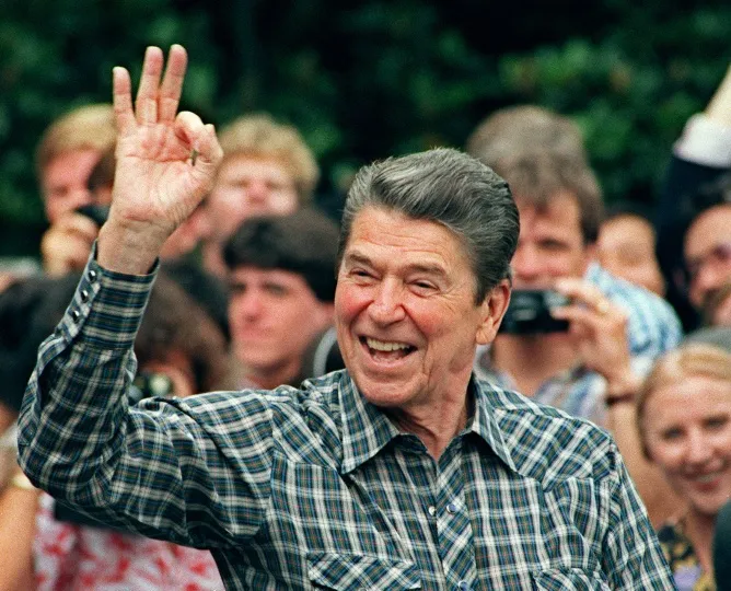 US President Ronald Reagan gestures as he leaves the White House for a weekend at Camp David in 1987.
