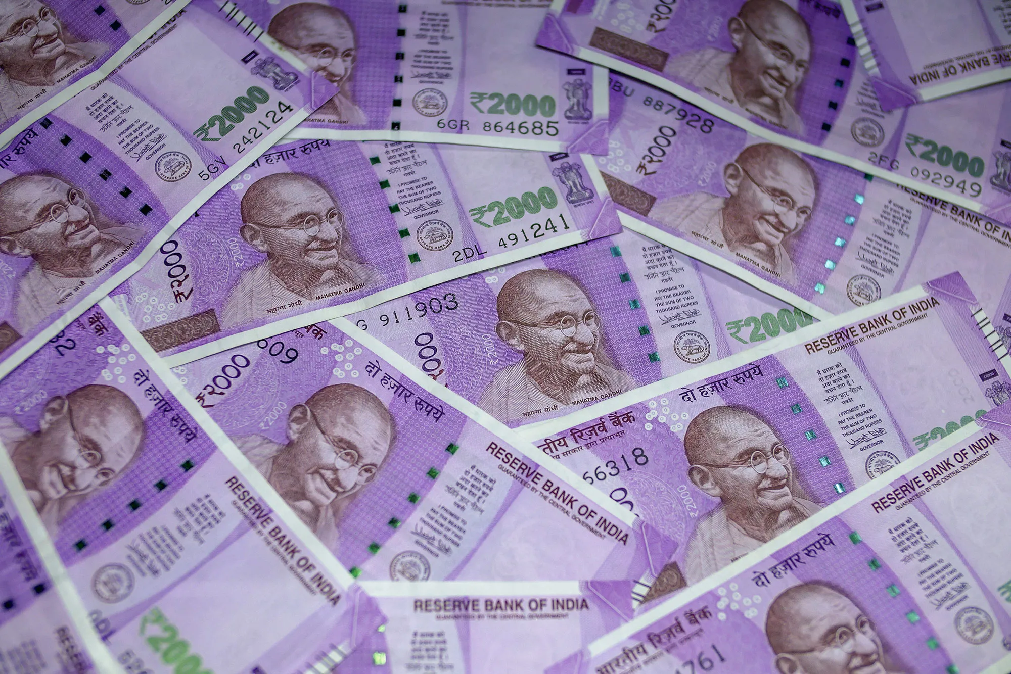 Indian two thousand rupee banknotes are arranged for a photograph in Mumbai, India, on Sunday, Jan. 29, 2016. Reviving India's growth and boosting demand are essential as gross domestic product is likely to grow 7.1 percent in the year through March, the slowest pace in three years -- and this is before considering the impact of currency shortages in an economy where 98 percent of consumer payments are made in cash.
