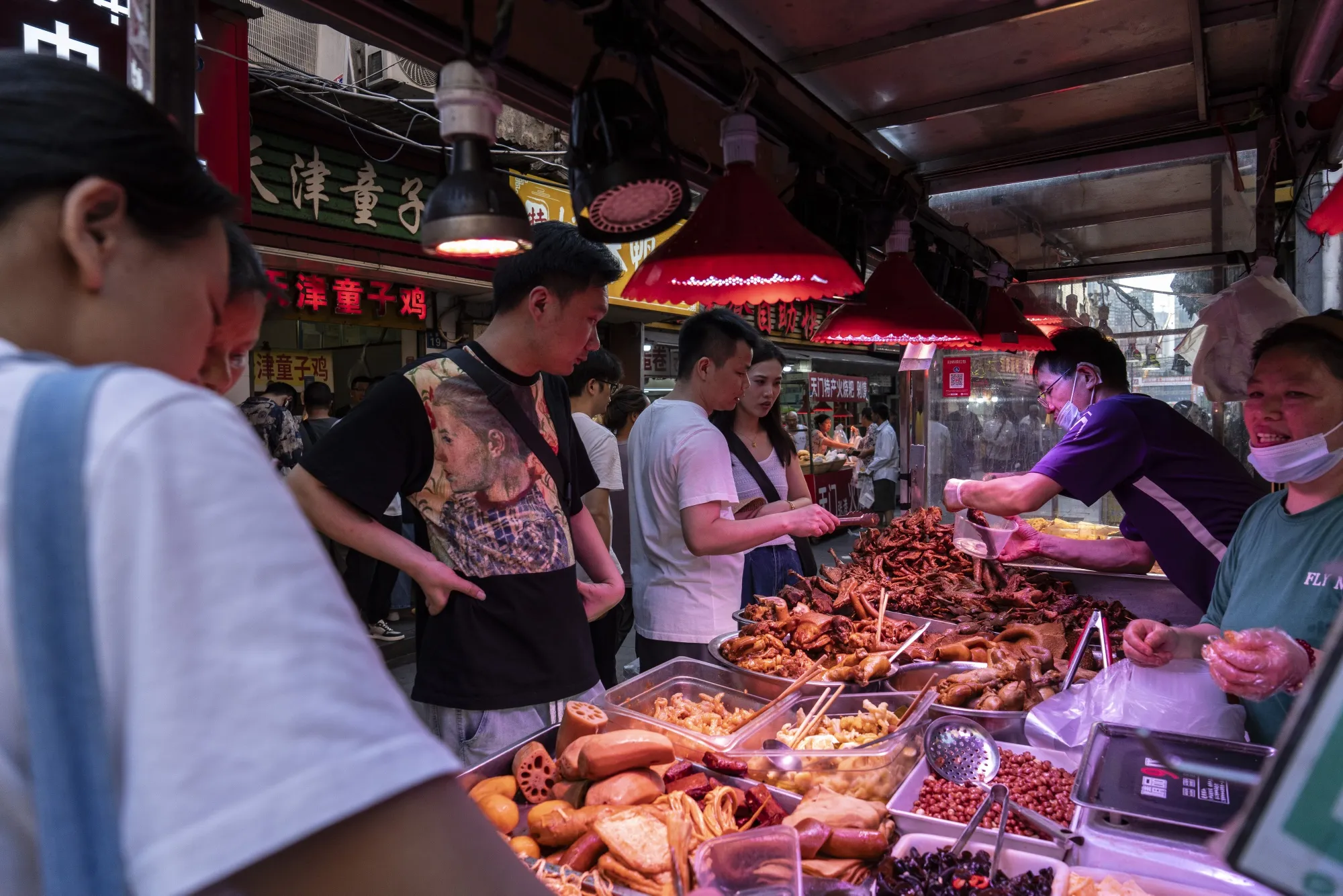 Customers purchase food at a stall in Wuhan, China.