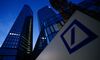 A logo sits on display in front of the Deutsche Bank AG headquarters at dawn in Frankfurt, Germany.