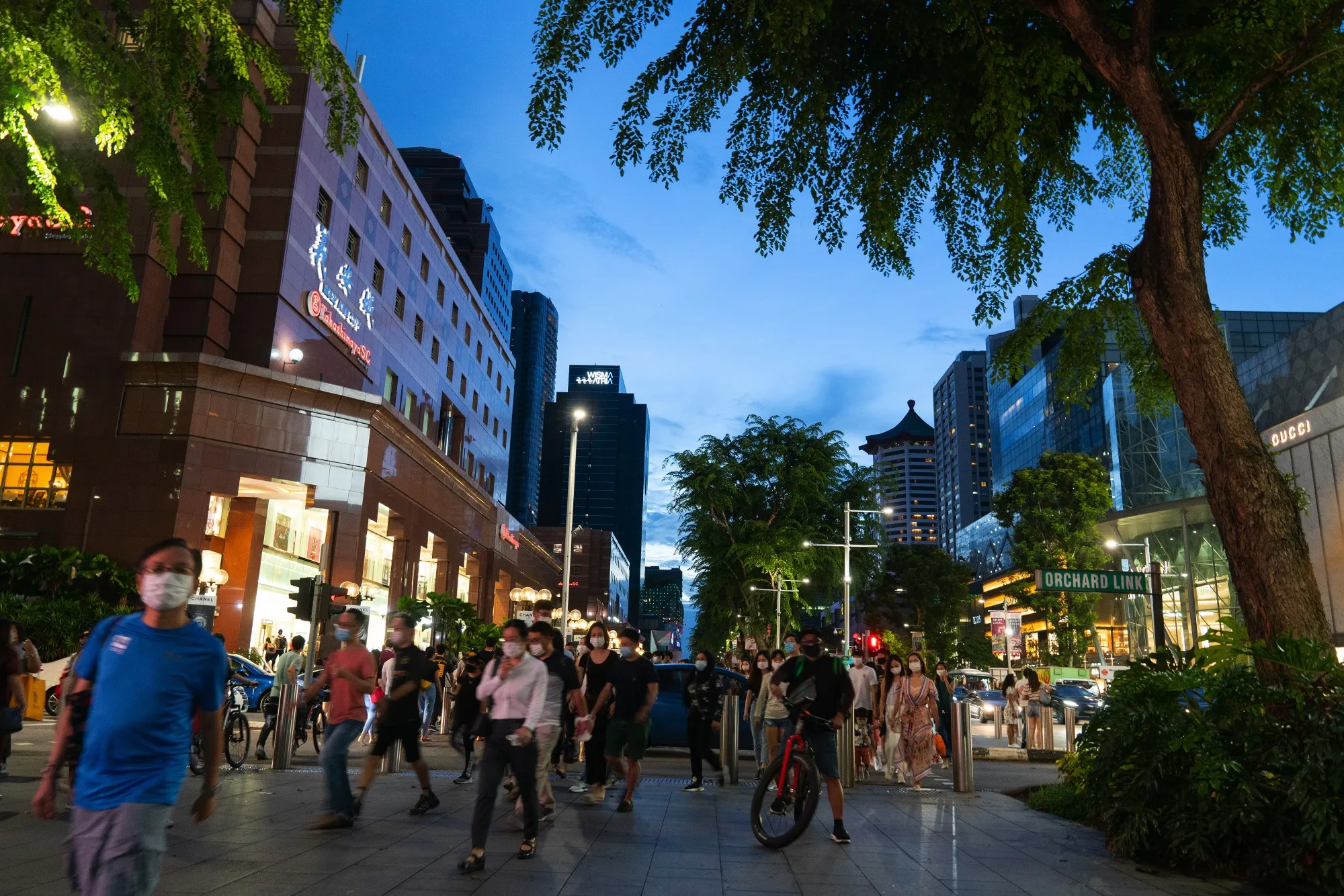 Pedestrians and shoppers on Orchard Road in Singapore.