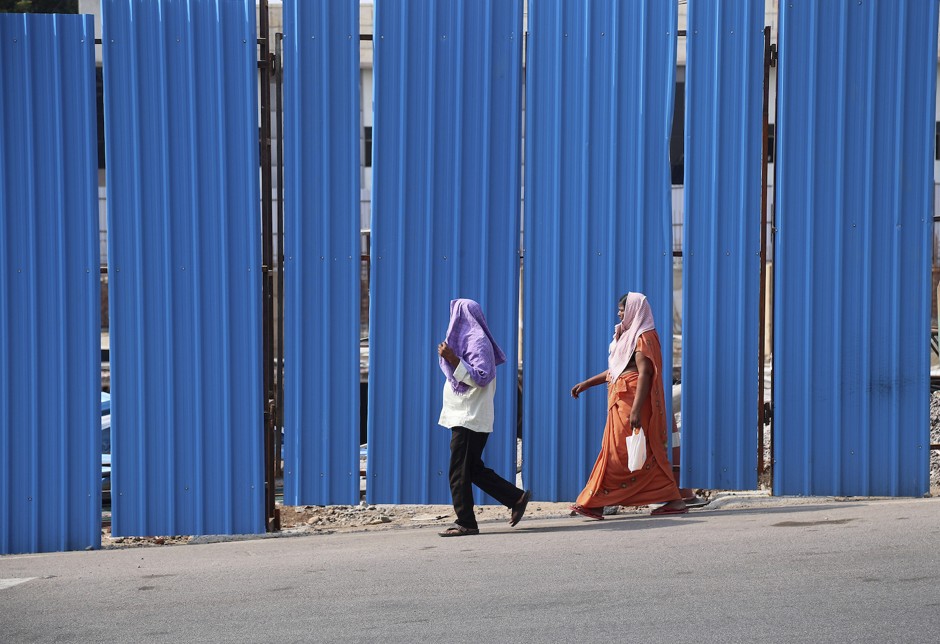 Pedestrians in Hyderabad shielding their heads from the sun during India's recent heat wave.