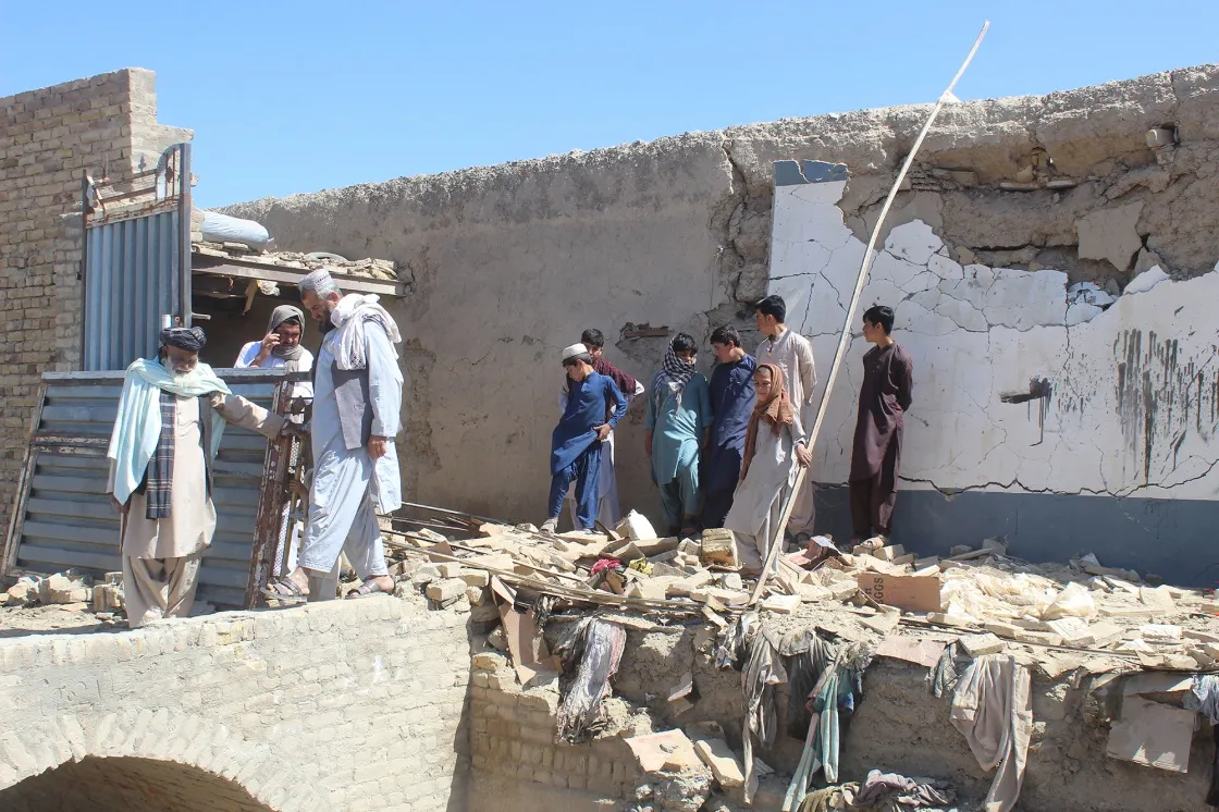 Residents gather at a damaged house after it was struck by a mortar shell in Chaman, Pakistan&nbsp;on April 28.