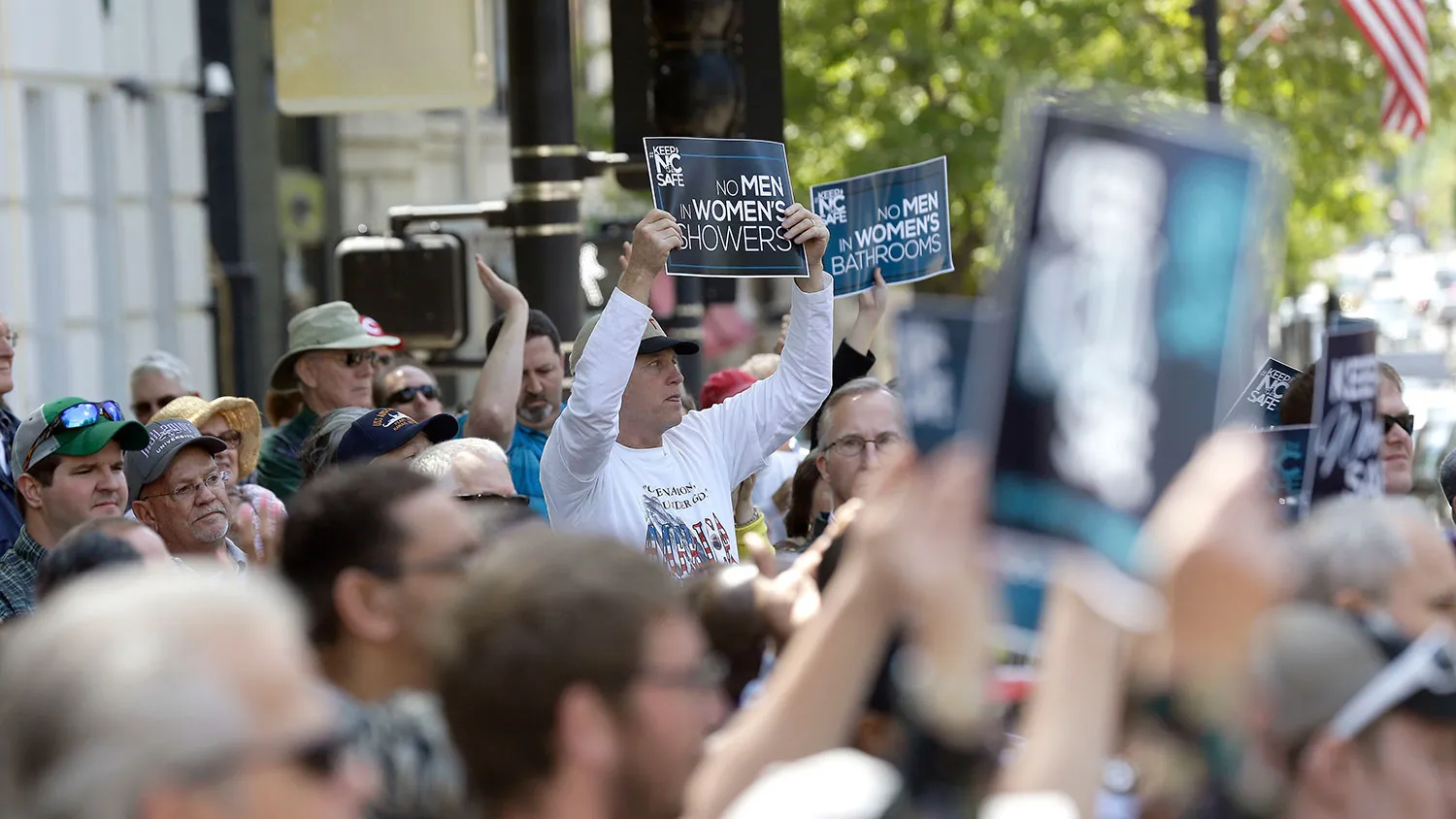 Supporters rally outside the North Carolina state capitol in Raleigh on April 11, 2016, in support of a law that blocks rules allowing transgender people to use the bathroom aligned with their gender identity.

