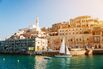 Sailboats In Sea Against Buildings In City