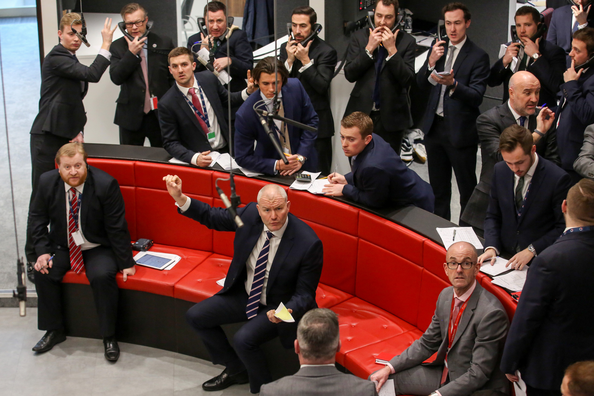 Traders react on the trading floor of the open outcry pit at the London Metal Exchange .