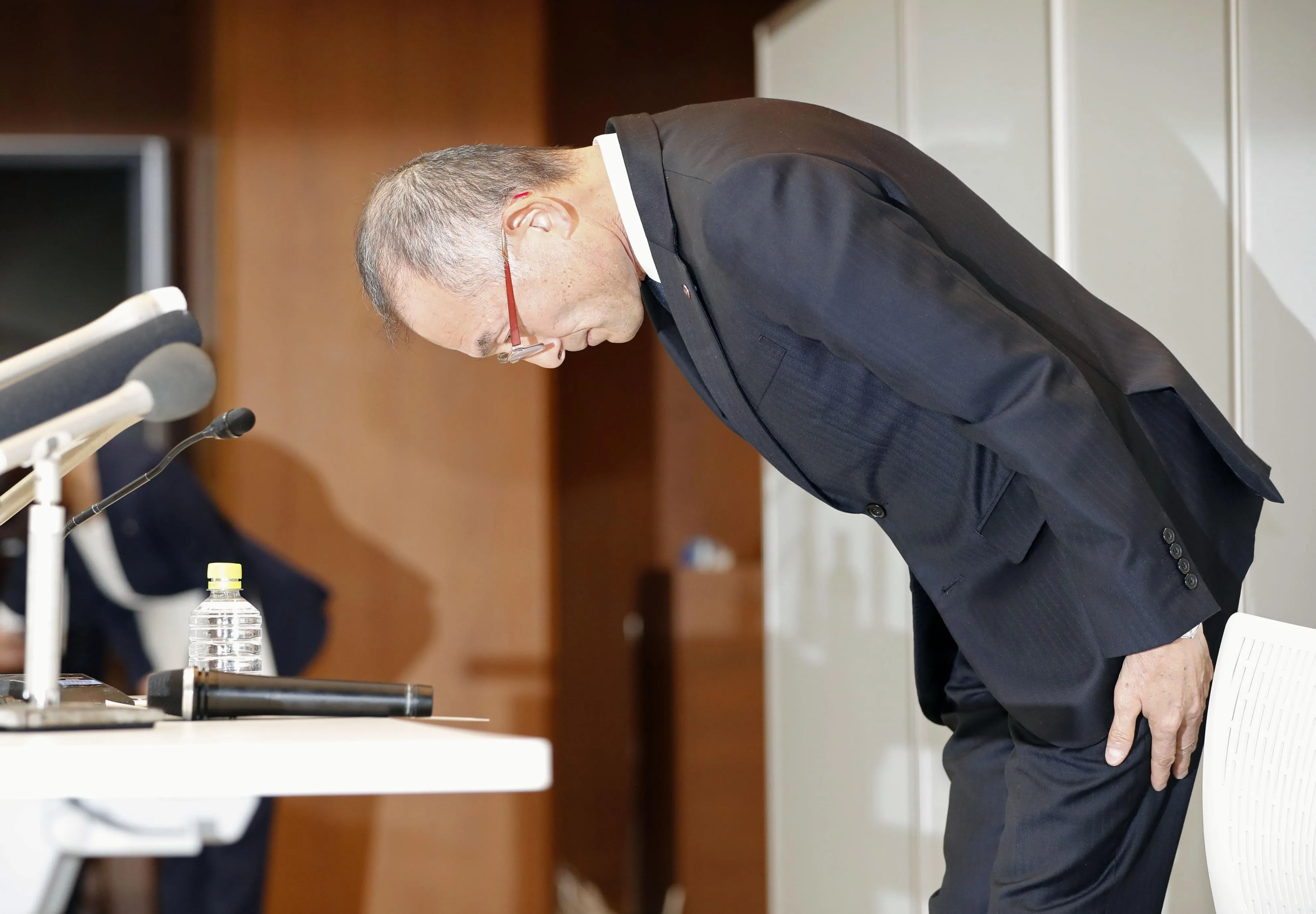 Kazuhisa Yokoyama, senior managing director of Takashimaya Corp., bows during a news conference in Tokyo on Dec. 27.