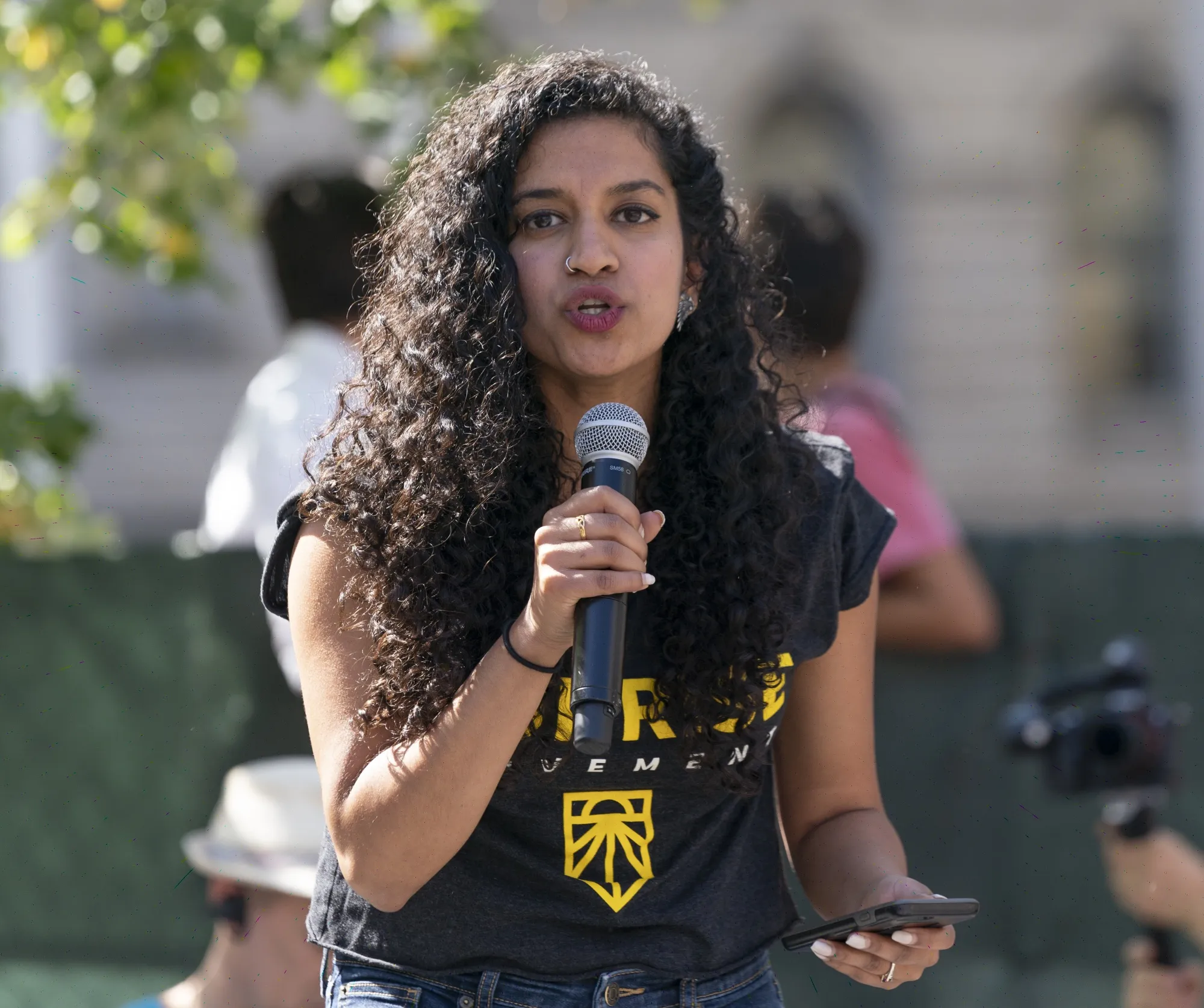 Varshini Prakash speaks on stage during NYC Climate Strike rally in 2019.