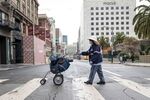A mail carrier makes her rounds in San Francisco in April. Like other front-line workers, postal employees face an elevated risk of coronavirus exposure.