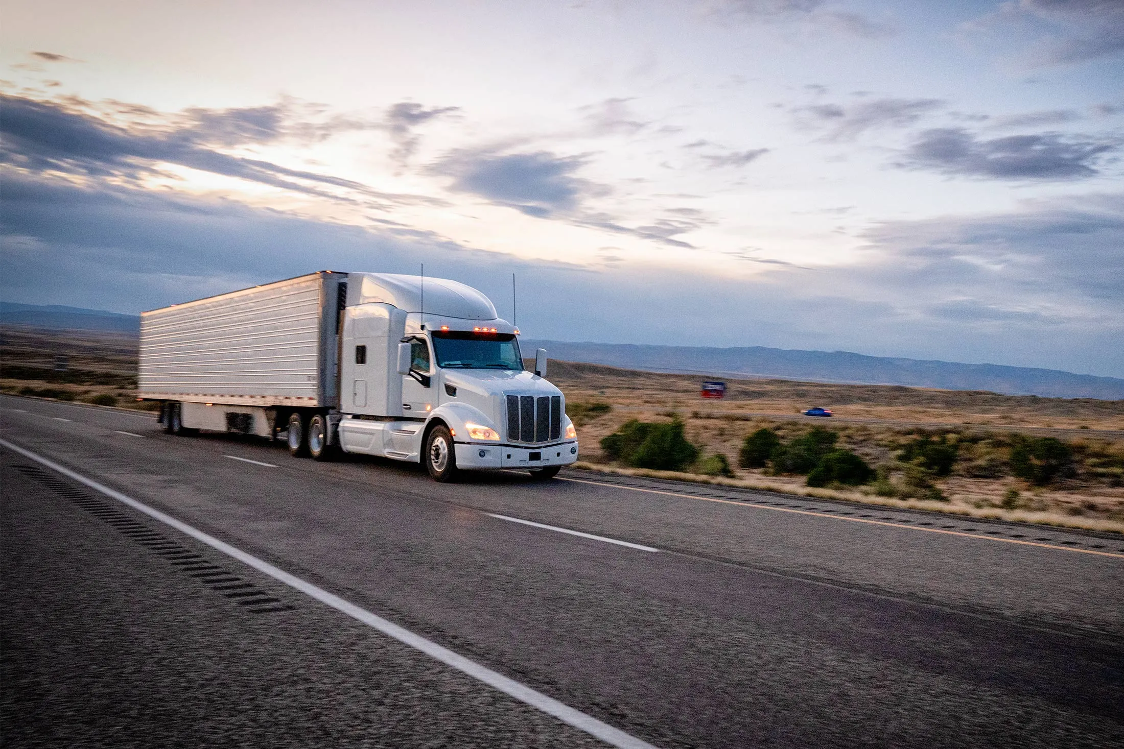 Big freight trucks on the open highway heading to their destinations to make deliveries.