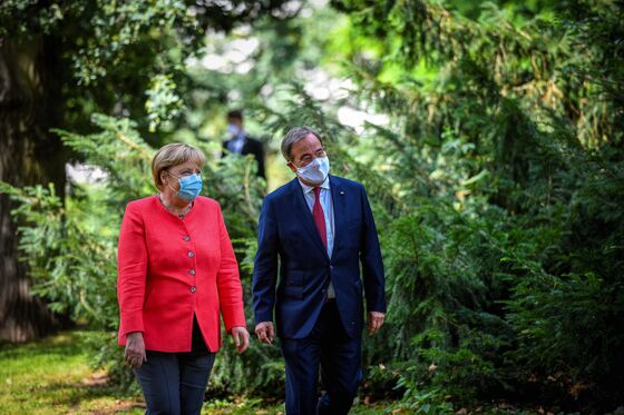 Merkel Weighs In on Succession in Visit to Contender’s Home Turf