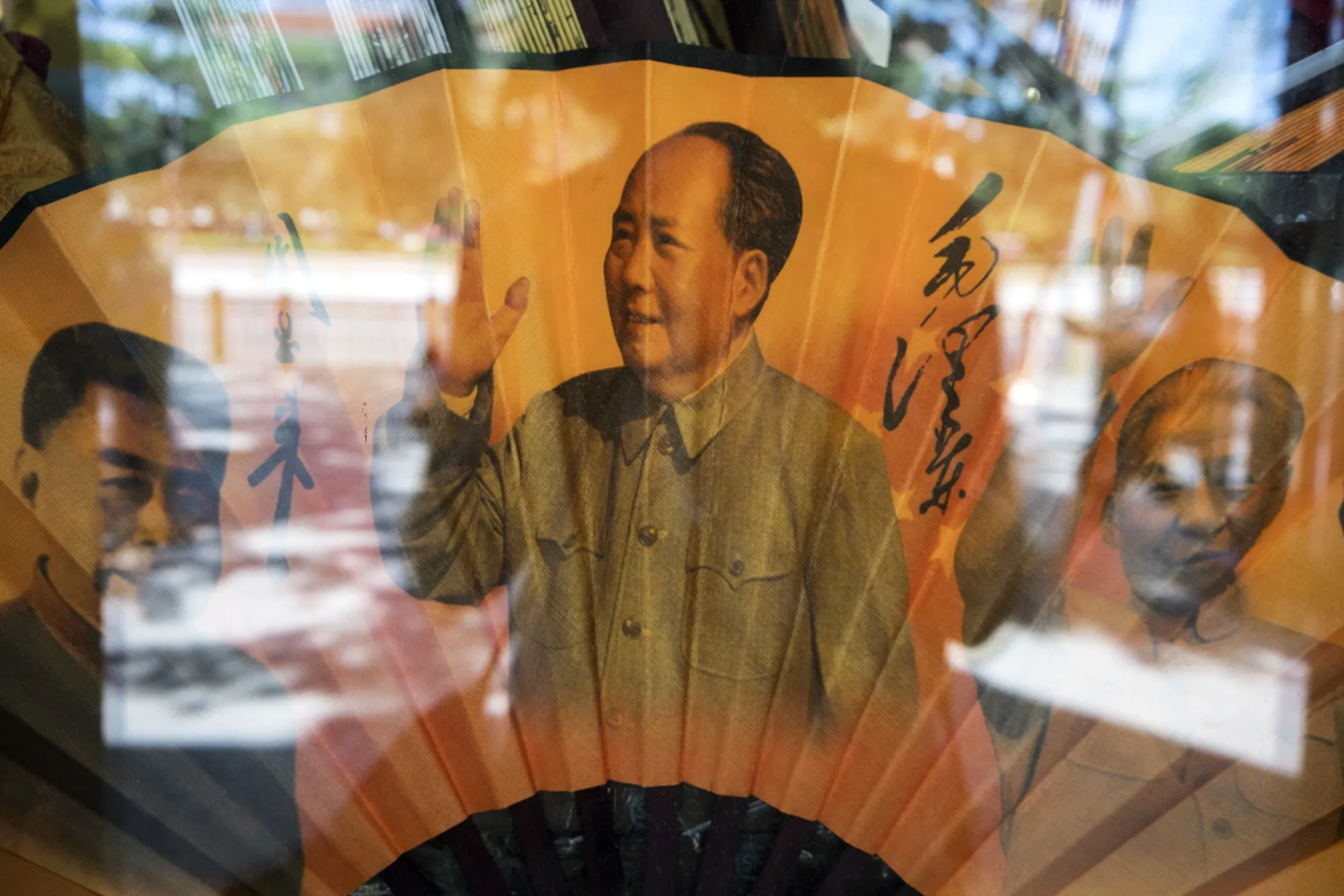 A paper fan featuring the portraits of former Chinese leaders Zhou Enlai, left, Mao Zedong, center, and Deng Xiaoping for sale in a store in Beijing in 2019.