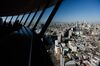 Visitors look out at the skyline from an observation deck in Tokyo, Japan, on Friday, Jan. 11, 2019. Japan’s key inflation gauge slowed in the first back-to-back decline since April, highlighting the difficulty of the Bank of Japan’s price goal ahead of its policy meeting next week.