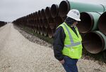 A worker walks through the pipe yard for TransCanada's Houston Lateral Project in Mont Belvieu, Texas, about 30 miles east of Houston on Wednesday, March 5, 2014.