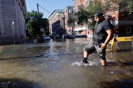 Urban Rowboat Rescues and Chest-Deep Water: Scenes of the Flood