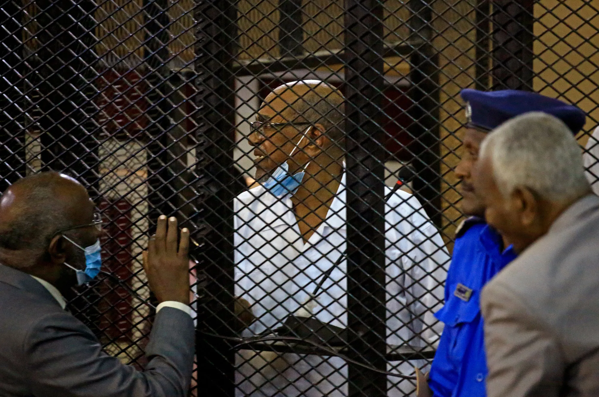 Omar al-Bashir inside the defendant's cage during his trial at a courthouse in Khartoum.&nbsp;