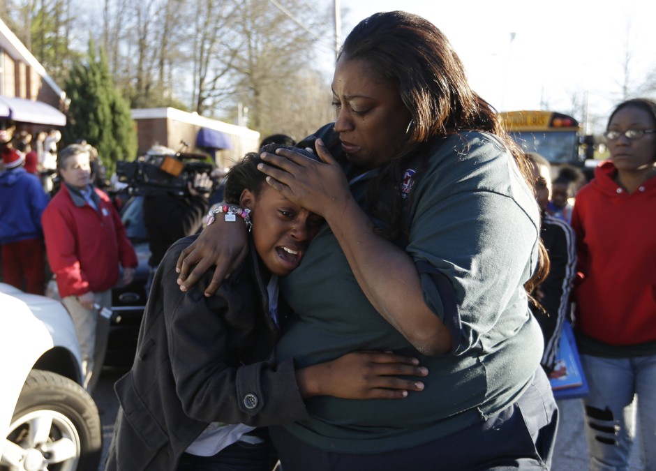 A woman comforts a child after a school shooting in Atlanta. 