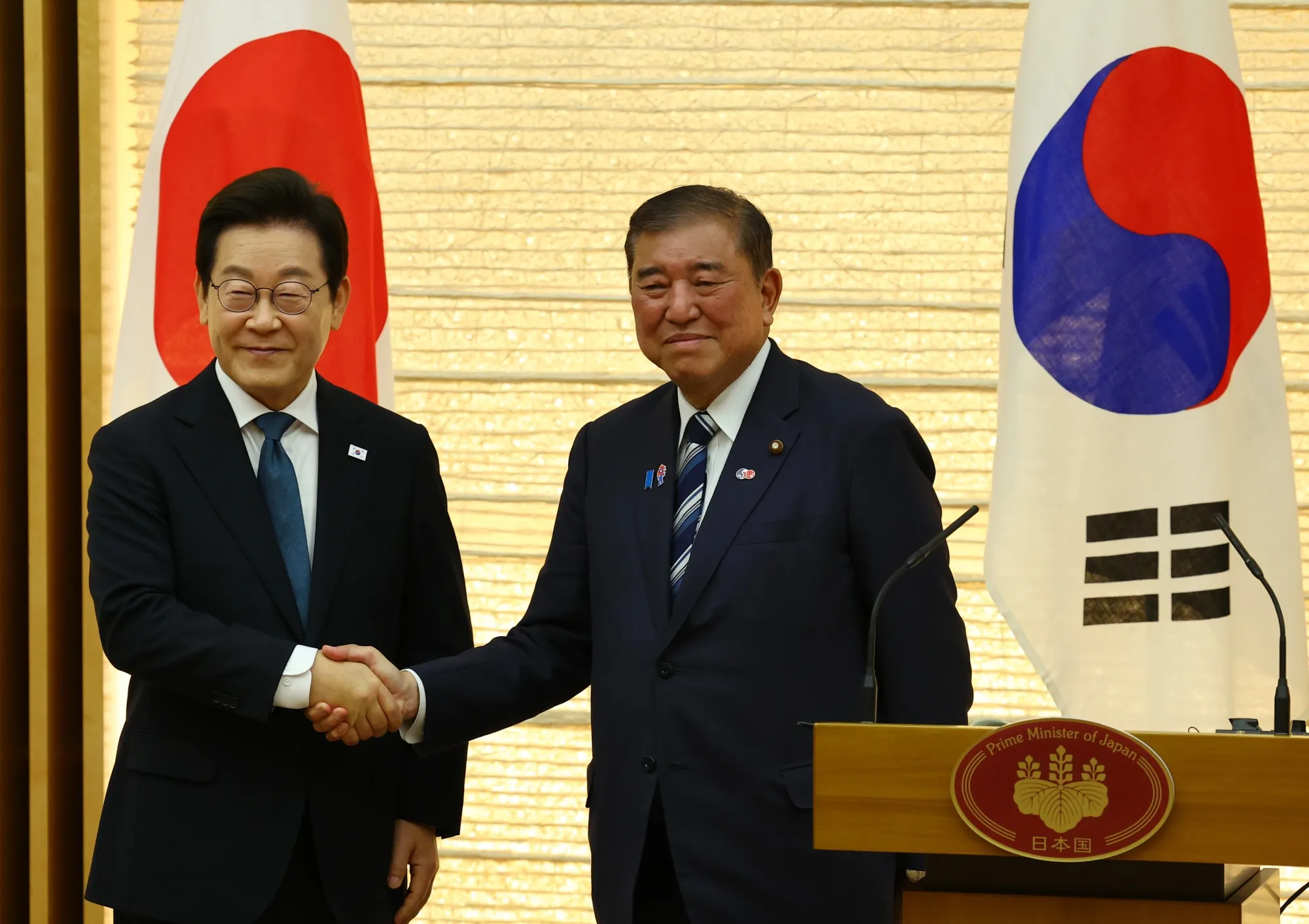 Lee Jae Myung, South Korea's president, left, and Shigeru Ishiba, Japan's outgoing prime minister, in Tokyo, on Aug. 23.