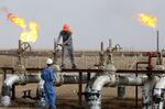 Iraqi labourers work at an oil refinery in the southern town Nasiriyah.