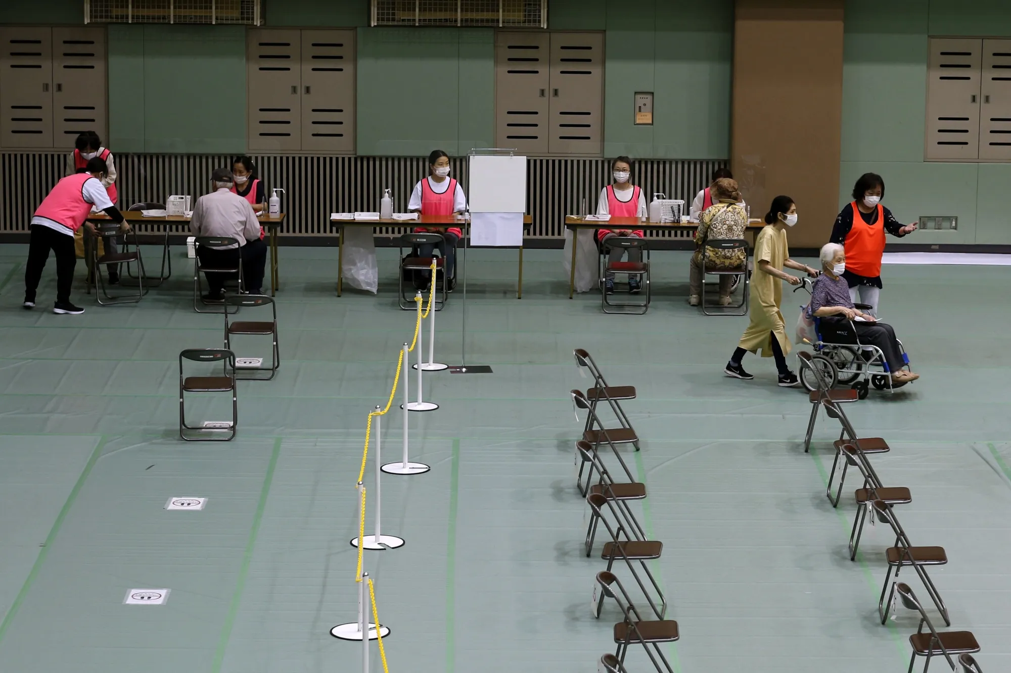 A woman arrives to receive a shot at an Osaka inoculation site in June.