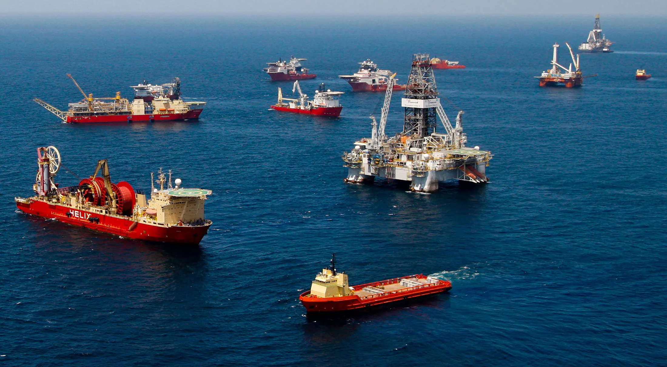 Vessels gather near Transocean Ltd.'s Development Driller III, right, at the BP Plc Macondo well site in the Gulf of Mexico off the coast of Louisiana, U.S., on Thursday, July 29, 2010. BP Plc may move up the schedule for a static kill attempt, which would involve pumping mud and cement to permanently plug its leaking Macondo oil well in the Gulf of Mexico. Thursday marked the 100th day of the largest oil spill in U.S. history, which began when the Deepwater Horizon drilling rig exploded on April 20.
