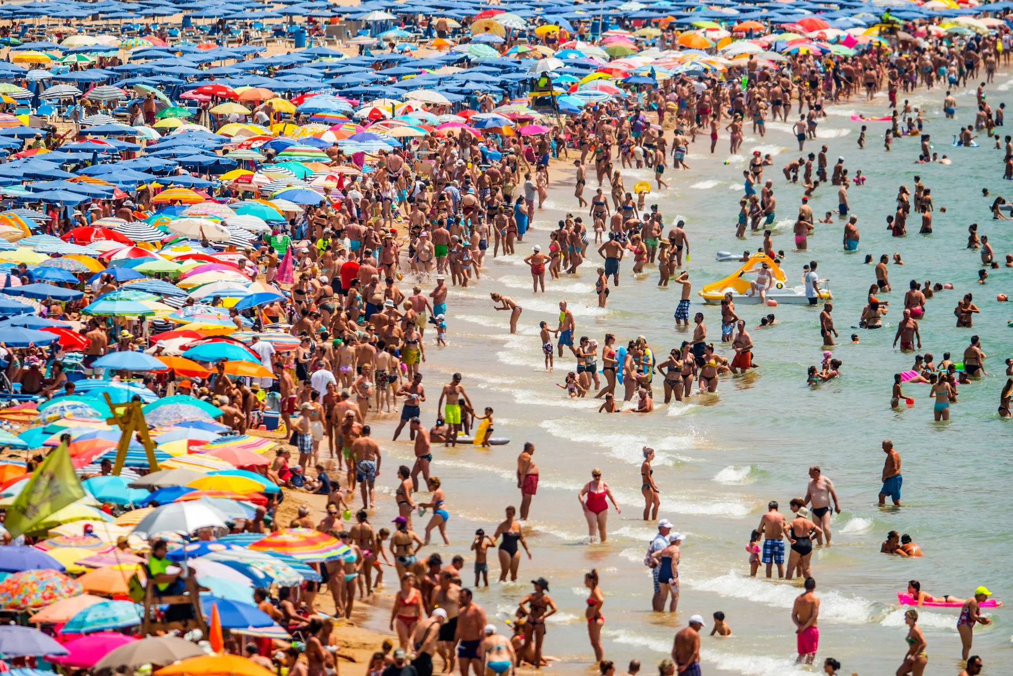 People sunbathe at Levante Beach on July 22, 2015 in Benidorm, Spain.