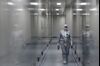 TOPSHOT - An employee wearing protective equipment walks in a passage at the headquarters of Russia's biotech company BIOCAD, which is developing its own vaccine against the new coronavirus and working on another one in cooperation with the country's virus research centre in Siberia, Vektor, in Strelna on May 20, 2020. (Photo by OLGA MALTSEVA / AFP) (Photo by OLGA MALTSEVA/AFP via Getty Images)