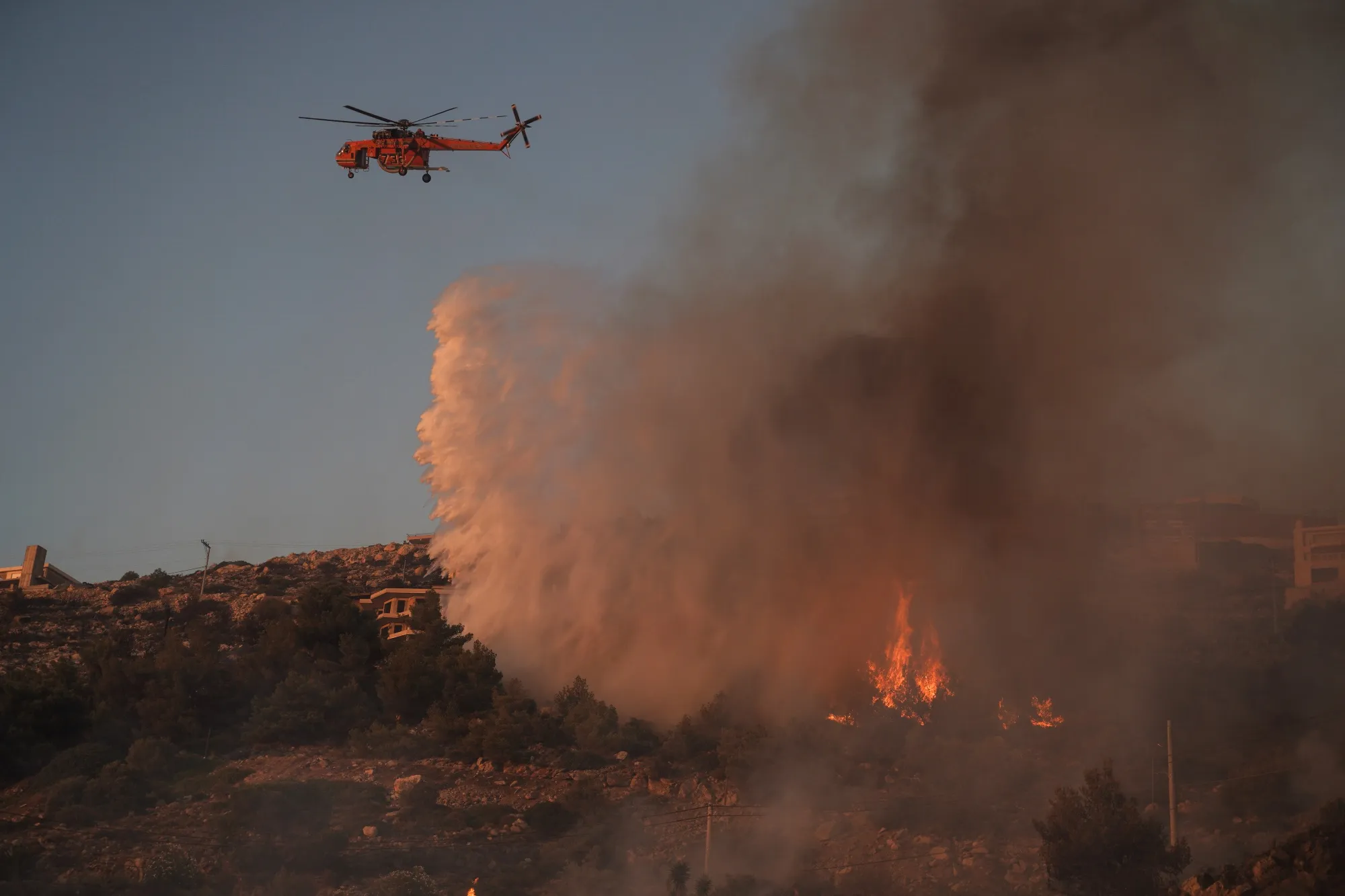 Greek firefighters battling to extinguish a wildfire in Saronida, a village south of Athens, Greece, in July 2023.&nbsp;