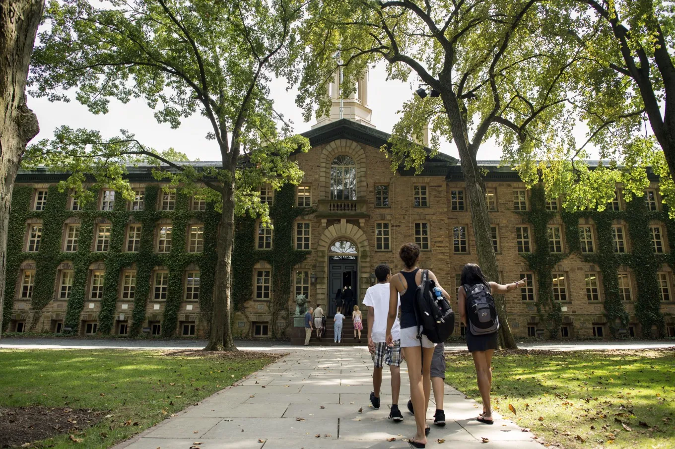 People walk on the Princeton University campus in Princeton, New Jersey, U.S., on Friday, Aug. 30, 2013.