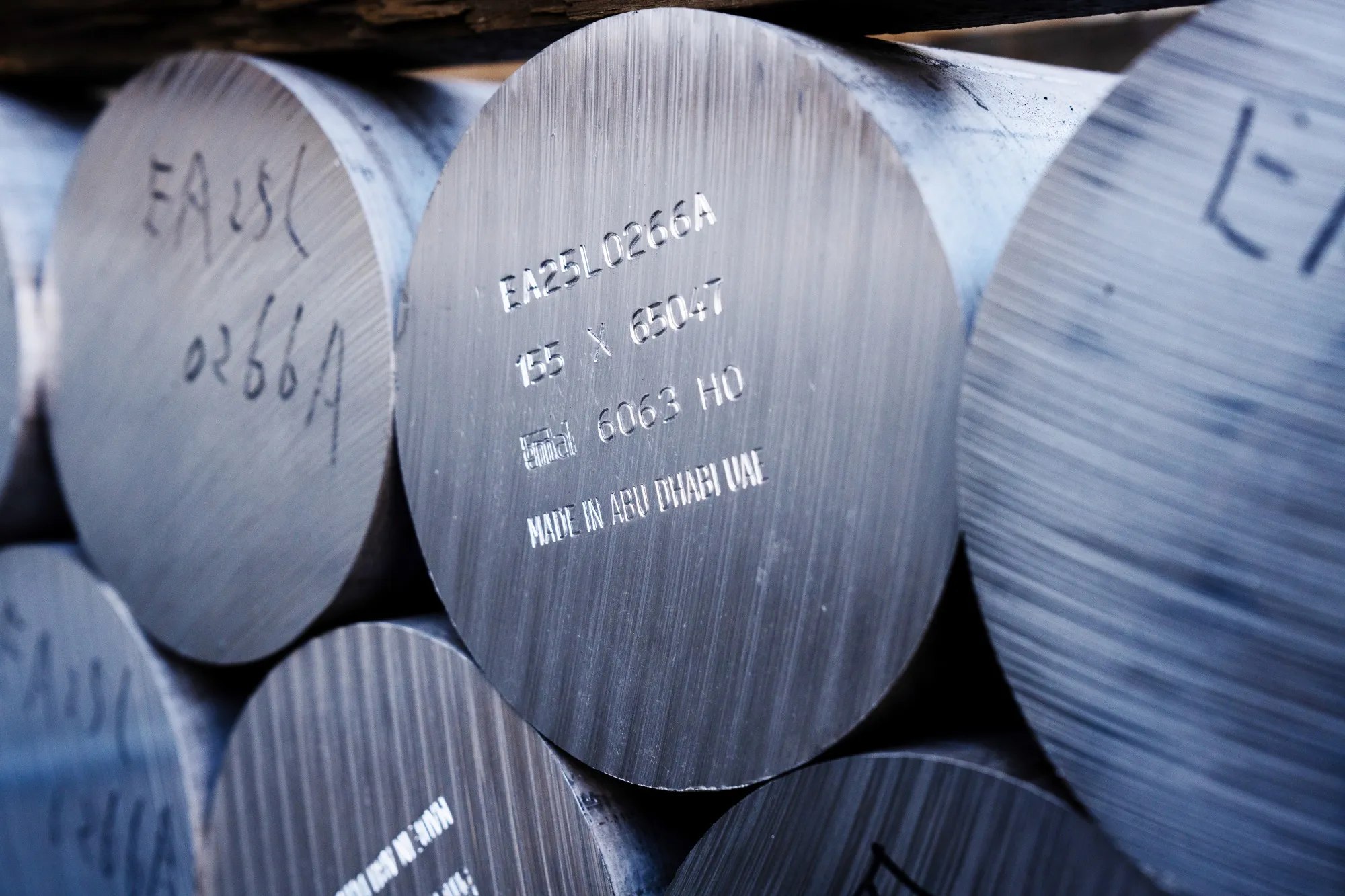 Aluminum billets marked "Made in Abu Dhabi UAE" at a factory in Kanie, Japan.