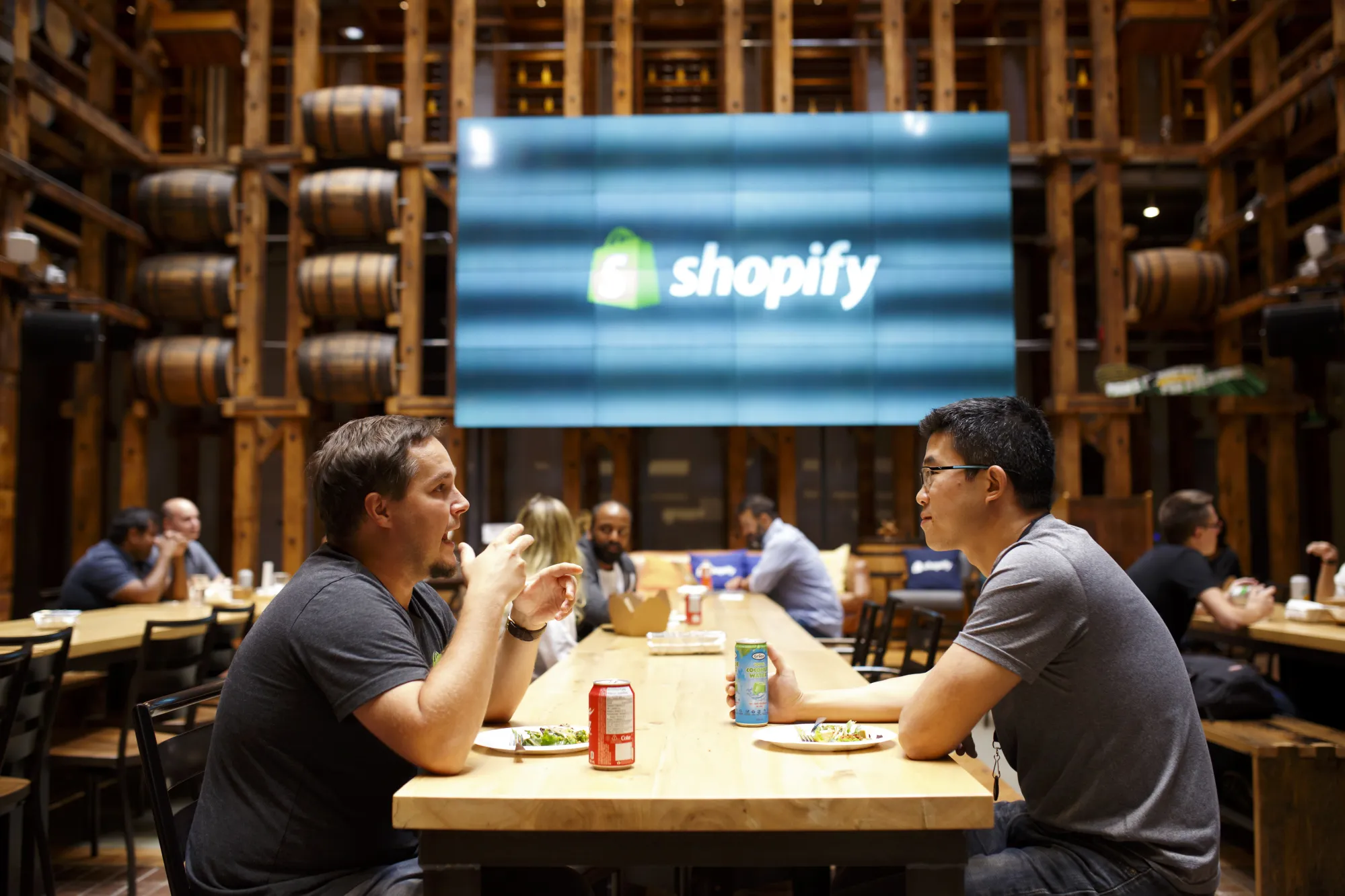 Employees eat in a common area at the Shopify Inc. office in Waterloo, Ontario, Canada.