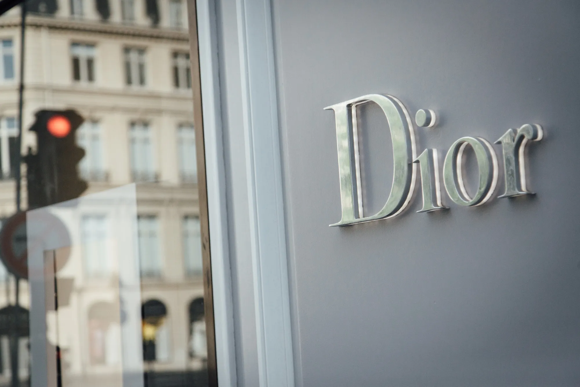A logo sits on a Christian Dior SE luxury goods store, operated by LVMH Moet Hennessy Louis Vuitton SE, on Avenue Montaigne in Paris, France, on Wednesday, May 6, 2020.&nbsp;