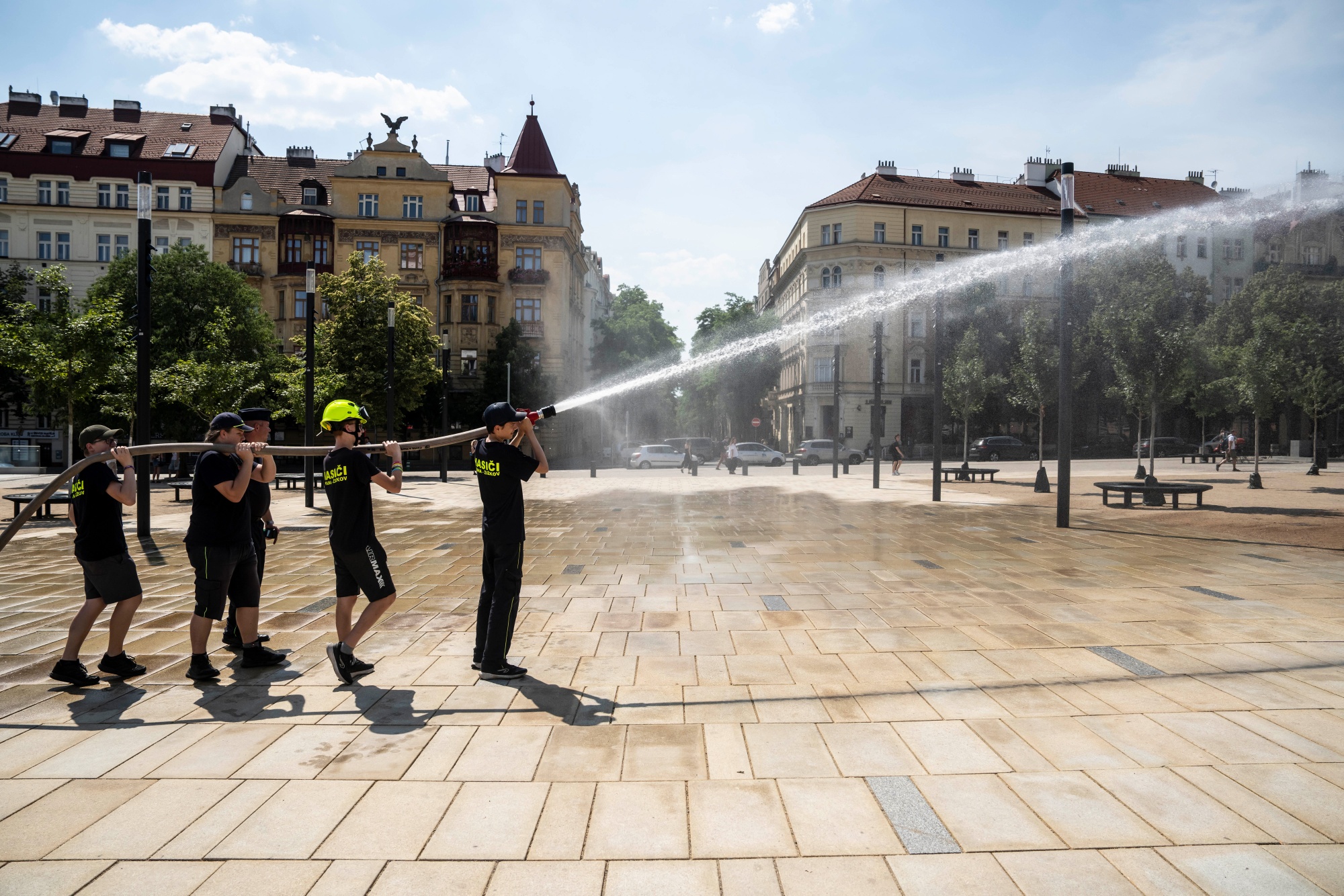 Volunteer firefighters spray a square with cooling water during high temperatures in Prague, Czech Republic, on Sunday, June 28, 2026. The heat wave was fueled by a high-pressure heat dome and atmospheric shifts linked to a developing El Niño. Photographer: Milan Jaros/Bloomberg