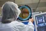 An employee inspects a wafer at a&nbsp;manufacturing facility in Germany.&nbsp;